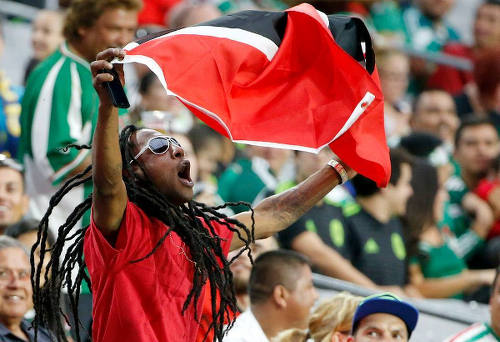 Photo: A Trinidad and Tobago football fan waves his flag during their 2015 CONCACAF Gold Cup fixture against Cuba in Phoenix. (Courtesy CONCACAF)