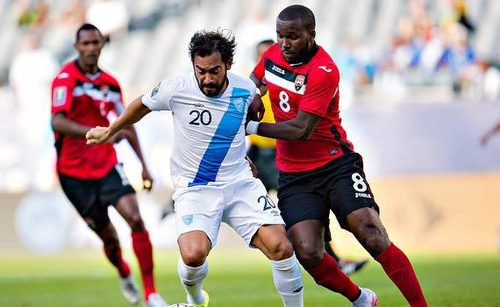 Photo: Trinidad and Tobago midfielder Khaleem Hyland (right) tackles Guatemala captain Carlos Ruiz in 2015 CONCACAF Gold Cup action. (Courtesy CONCACAF)