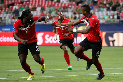 Photo: Trinidad and Tobago captain Kenwyne Jones (left) congratulates scorer Sheldon Bateau (right) after his 2015 Gold Cup goal against Cuba. Looking on is Andre Boucaud. (Courtesy CONCACAF)