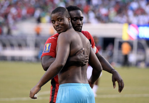 Photo: Trinidad and Tobago football captain Kenwyne Jones (background) hugs international teammate and goalkeeper Marvin Phillip after their penalty shootout loss to Panama in the 2015 CONCACAF Gold Cup quarterfinal. (Copyright Jewel Samad/AFP 2015)