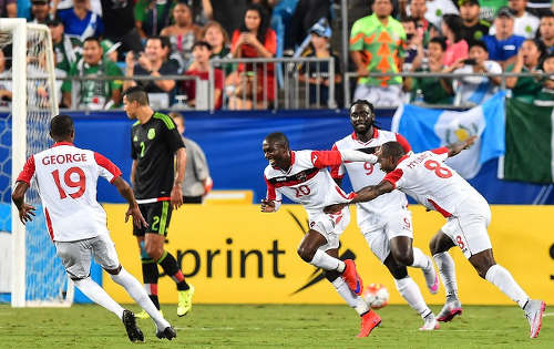 Photo: Trinidad and Tobago midfielder Keron Cummings (third from right) celebrates his second strike against Mexico with teammates (from right) Khaleem Hyland, Kenwyne Jones and Kevan George at the 2015 CONCACAF Gold Cup. (Copyright Nicholas Kamm/AFP 2015)