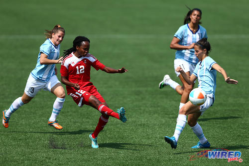 Photo: Trinidad and Tobago winger Ahkeela Mollon (centre) whips in a cross during their 2015 Pan Am contest with Argentina. The Trinidad and Tobago and Argentina teams played to a 2-2 draw. (Courtesy Allan V Crane/Wired868)