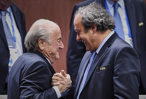 Photo: Then UEFA president Michel Platini (right) congratulates FIFA president Sepp Blatter after his re-election on 29 May 2015. (Copyright Michael Buholzer/AFP 2015)