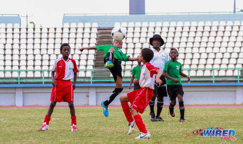 Photo: An Uprising Youths player (centre) keeps his eye on the ball against San Juan Jabloteh in the Republic Bank National Youth Cup Under-11 final at the Larry Gomes Stadium, Malabar. (Courtesy Sinead Peters/Wired868)