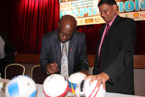 Photo: Former Chaguanas West MP and FIFA vice president Jack Warner (left) signs footballs for Trinidad Guardian sport editor Valentino Singh. (Copyright Guardian.co.tt)