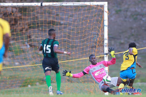 Photo: Carapichaima East Secondary goalkeeper Jeremiah Phillips (centre) denies Speyside High School's Jakeb Douglas in 2015 SSFL action in Speyside, Tobago. (Courtesy Allan V Crane/Wired868)