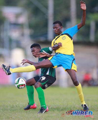 Photo: Carapichaima East Secondary's Micah Serrette (left) tries to keep the ball from Speyside High School's Elder Kamarie during 2015 SSFL action in Speyside, Tobago. (Courtesy Allan V Crane/Wired868)