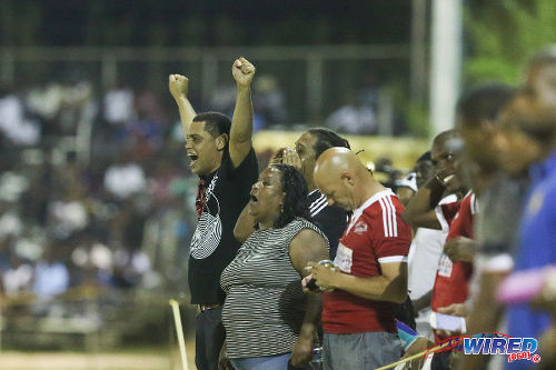 Photo: The "Central Choir", accompanied by Central FC operations manager Kevin Harrison (centre), look on from the sidelines at the Mahaica Oval in 2015 Pro League action. Harrison served as Sport Minister Brent Sancho's advisor, last year, and is a former voluntary worker with the UK's Professional Footballers' Association (PFA). (Courtesy Chevaughn Christopher/Wired868)