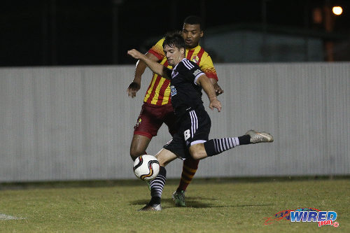 Photo: Central FC midfielder Sean De Silva (foreground) volleys home his double while Point Fortin Civic left back Andrei Pacheco looks on at the Mahaica Oval on 26 September 2015. (Courtesy Chevaughn Christopher/Wired868)