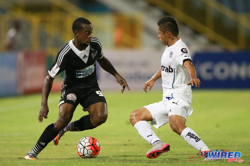 Photo: Central FC attacker Marcus Joseph (left) takes on a Comunicaciones player during CONCACAF Champions League action. (Courtesy Allan V Crane/Wired868)