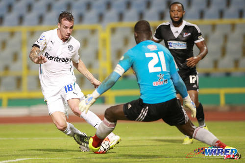 Photo: Comunicaciones attacker Emiliano Lopez (left) dribbles around Central FC goalkeeper Jan-Michael Williams (centre) while defender Marcelle Francois looks on during 2015 CONCACAF Champions League action. (Courtesy Allan V Crane/Wired868)