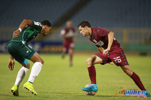 Photo: Deportivo Saprissa winger Daniel Colindres (right) tries to find a way past W Connection captain and defender Alvin Jones in 2015/16 CONCACAF Champions League action. (Courtesy Allan V Crane/Wired868)