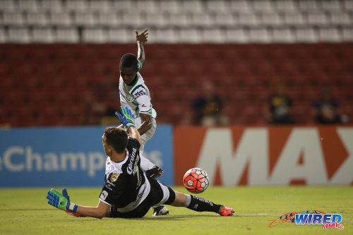 Photo: Santos Laguna goalkeeper Agustin Marchesin uses his right leg to block a shot from W Connection attacker Dimitrie Apai during 2015 CONCACAF Champions League action. (Courtesy Allan V Crane/Wired868)