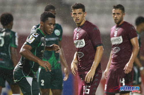 Photo: W Connection defender Maurice Ford (left) keeps a close eye on Deportivo Saprissa star Daniel Colindres (centre) during 2015 CONCACAF Champions League action. (Courtesy Allan V Crane/Wired868)