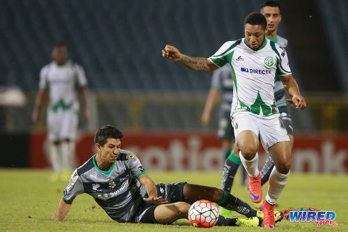 Photo: W Connection attacker Shahdon Winchester (right) evades a tackle from Santos Laguna defender Jesus Molina during 2015/16 CONCACAF Champions League action. (Courtesy Allan V Crane/Wired868)