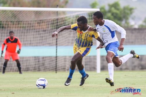 Photo: Fatima College's Jonathan Casimire (left) tries to hold off Presentation College's Kori Cupid in 2015 SSFL action. (Courtesy Allan V Crane/Wired868)