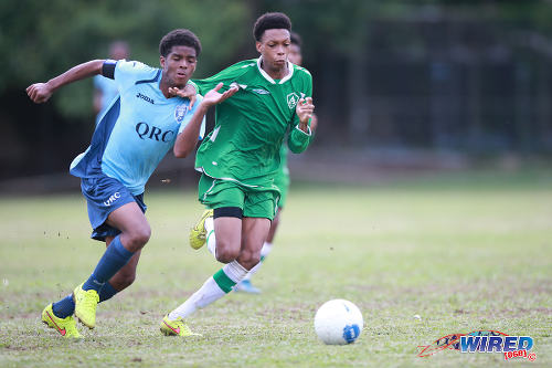 Photo: QRC midfielder Joash Williams (left) tries to outrun St Augustine Secondary midfielder Jesse Joseph during 2015 SSFL action. (Courtesy Allan V Crane/Wired868)