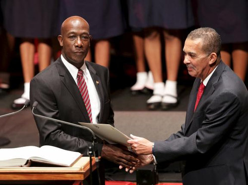 Photo: President Anthony Carmona (right) swears in Prime Minister Dr Keith Rowley. (Copyright Reuters)