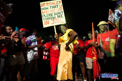 Photo: PNM supporters poke fun at the outgoing Prime Minister on 7 September 2015 at Balisier House. (Courtesy Allan V Crane/Wired868)