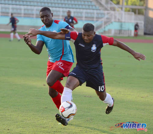 Photo: Police FC's Jason Boodram (right) holds off Marabella Family Crisis Centre's Ghmyo Harper during a 2015/16 CNG NSL Premiership Division contest. (Courtesy DPI Photography/Wired868)