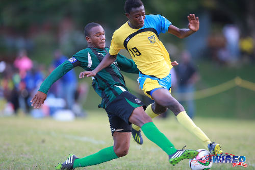 Photo: Carapichaima East Secondary's Cadiz Chandler (left) tackles Speyside High School's Shaffie McKenzie during 2015 SSFL Premier Division action today in Speyside, Tobago. (Courtesy Allan V Crane/Wired868)