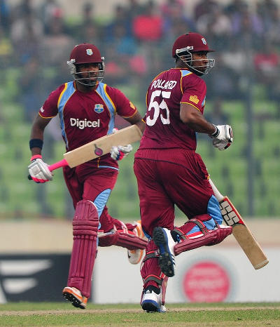 Photo: Dwayne Bravo (left) and Kieron Pollard cross for a run during active duty for the West Indies Cricket Team,. The pair have often been hit with the blunt instrument of exclusion from the WI squad. (Copyright AFP 2015)