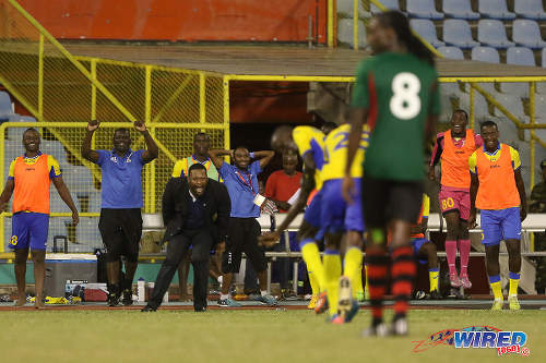 Photo: Defence Force coach Marvin Gordon (third from left) and his substitutes' bench erupts after Jerwyn Balthazar's screaming strike against San Juan Jabloteh in the 2015 First Citizens Cup. (Courtesy Chevaughn Christopher/Wired868)