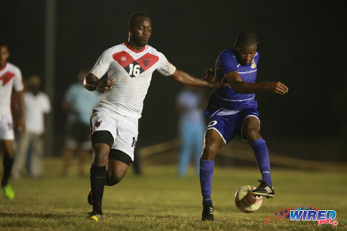 Photo: Defence Force midfielder Josimar Belgrave (right) tries to elude a Tobago FC Phoenix 1976 player during 2015/16 CNG National Super League action at the Canaan Recreation Grounds, Tobago. (Courtesy Allan V Crane/Wired868)