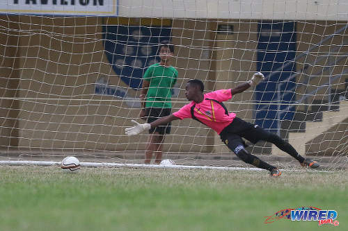 Photo: St Benedict's College goalkeeper Jabari Gray dives in vain after an effort from Fatima College attacker Sebastien Camacho, during a 2015 SSFL contest. The shot crept just wide. (Courtesy Chevaughn Christopher/Wired868)