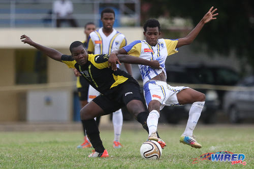 Photo: St Benedict's College midfielder Tyrik Eastman (left) tussles for possession with Fatima College midfielder Kyon Williams during 2015 SSFL action. (Courtesy Chevaughn Christopher/Wired868)