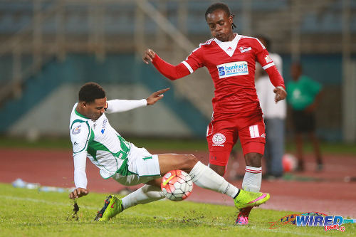 Photo: W Connection captain Alvin Jones (left) chops down Central FC midfielder Darrell Mitchell during the 2015 First Citizens Cup final in Couva. (Courtesy Allan V Crane/Wired868)