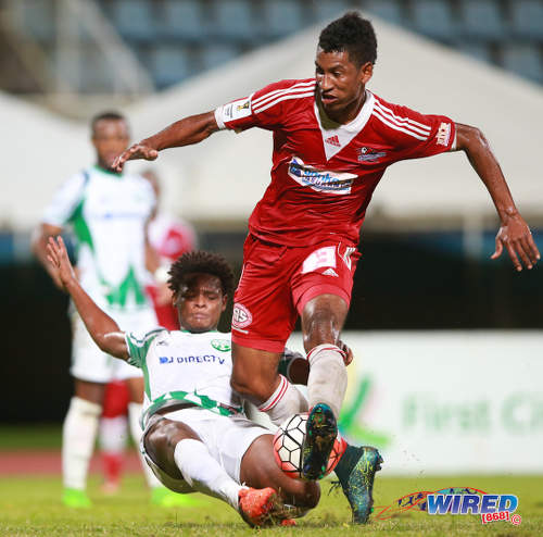 Photo: W Connection defender Triston Hodge (left) stops Central FC striker Willis Plaza with a superb tackle in the 2015 First Citizens Cup final. (Courtesy Allan V Crane/Wired868)