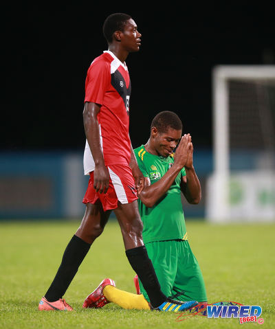 Photo: Guaya United Carlon Hughes (right) thanks the heavens after his crucial goal in his team's 2015 CNG National Super League Knock Out semifinal win over Tobago FC Phoenix 1976 at the Ato Boldon Stadium in Couva. (Courtesy Kerlon Orr/Wired868)