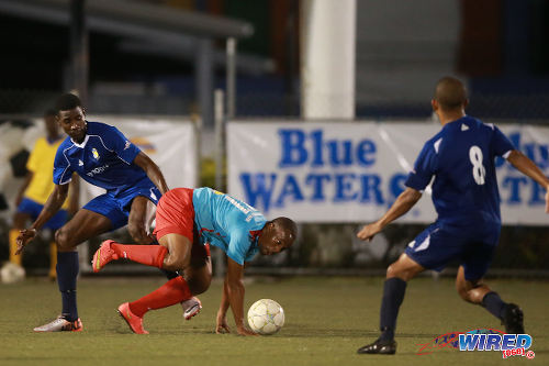 Photo: Marabella Family Crisis Centre substitute Arvid Applewhite (centre) tries to force his way between FC Santa Rosa players Claudius Howard (left) and Shaka Pilgrim during 2015/16 CNG NSL Premiership Division action in Macoya. (Courtesy Allan V Crane/Wired868)