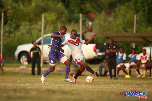 Photo: Tobago FC Phoenix 1976 attacker Le'jandro Williams (right) tries to elude a Defence Force player during CNG National Super League action in Canaan, Tobago. (Courtesy Allan V Crane/Wired868)