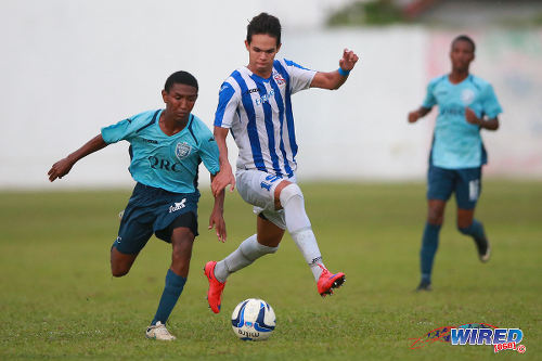 Photo: QRC playmaker John-Paul Rochford (left) keeps the ball from St Mary's College attacker Ethan Shim during 2015 SSFL action at Serpentine Road. Rochford is expected to be a key figure for the Trinidad and Tobago National Under-17 Team. (Courtesy Allan V Crane/Wired868)