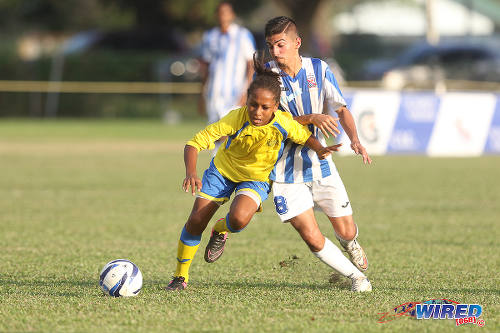 Photo: Shiva Boys HC substitute Judah Garcia (left) beats St Mary's College midfielder Daniel Conocchiari to the ball during 2015 SSFL action at Serpentine Road. Garcia is a member of the current Trinidad and Tobago National Under-17 Team. (Courtesy Chevaughn Christopher/Wired868)