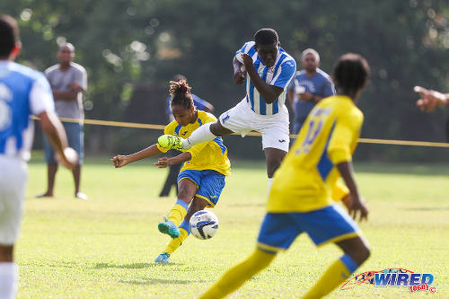 Photo: Shiva Boys HC star Tyrel "Pappy" Emmanuel (centre) drives towards goal while St Mary's College midfielder Nathan Harte (airborne) makes a vain attempt at a block during 2015 SSFL action. (Courtesy Chevaughn Christopher/Wired868)