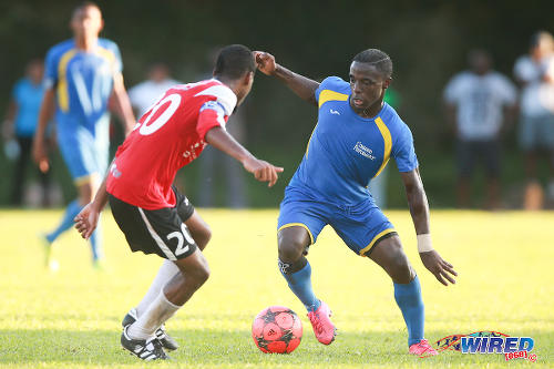 Photo: Shiva Boys HC attacker Quinn Rodney (right) takes on St Anthony's College defender Brent Joel during 2015 SSFL action in Westmoorings. (Courtesy Kerlon Orr/Wired868)