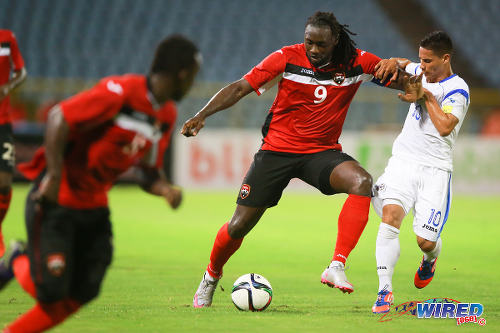 Photo: Trinidad and Tobago captain Kenwyne Jones (centre) holds off Nicaragua midfielder Elvis Figueroa during international friendly action at the Hasely Crawford Stadium on 13 October 2015. (Courtesy Allan V Crane/Wired868)