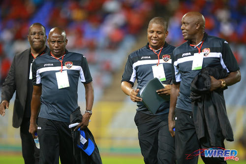 Photo: Trinidad and Tobago National Senior Team technical staff members (from right) Michael "Brow" Maurice, Derek King, Hutson "Barber" Charles and William Wallace exchange ideas before kick off against Nicaragua on 13 October 2015. (Courtesy Allan V Crane/Wired868)