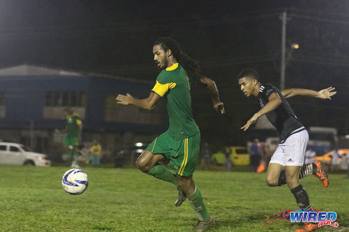 Photo: Barrackpore United's Dwane James (left) takes Saddle Hill Hotspur's Darius Rawlins for a run during CNG National Super League (NSL) Championship Division action in Barrackpore. (Courtesy Chevaughn Christopher/Wired868)
