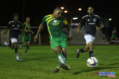 Photo: Barrackpore United right back Kevon Forrester (centre) passes the ball while Saddle Hill midfielder Sean Ramdoo (right) looks on during 2015 CNG National Super League (NSL) Championship Division action in Barrackpore. (Courtesy Chevaughn Christopher/Wired868)