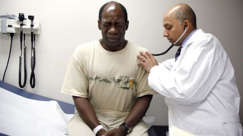 Photo: A doctor tends to his patient. (Copyright BET)