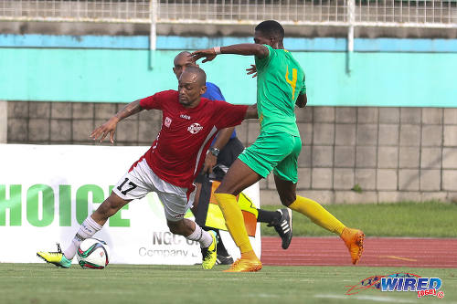 Photo: Petrotrin Palo Seco winger Lester Edwards (left) holds off Guaya United left back Kheelon Ferrier during NSL Knock Out action in 2015. (Courtesy Chevaughn Christopher/Wired868)