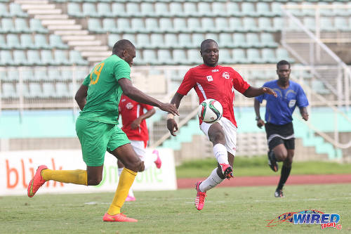 Photo: Petrotrin Palo Seco striker Sylvester Teesdale (centre) plays the ball in front of the watchful eye of Guaya United defender Beville Joseph in the 2016 NSL Knock Out final. (Courtesy Chevaughn Christopher/Wired868)