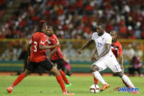 Photo: United States forward Jozy Altidore (right) runs at the Trinidad and Tobago defence during 2018 World Cup qualifying action at the Hasely Crawford Stadium. (Courtesy Allan V Crane/Wired868)