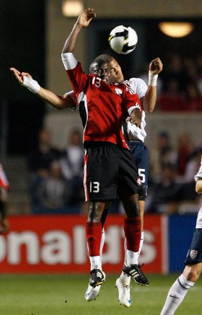 Photo: Trinidad and Tobago striker Cornell Glen (front) jumps for the ball with United States defender Oguchi Onyewu during 2010 World Cup qualifying action. (Copyright AFP 2015)