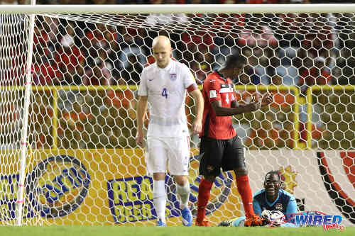 Photo: Trinidad and Tobago goalkeeper Jan-Michael Williams (right) enjoys a calm moment with teammate Sheldon Bateau (centre) and United States midfielder Michael Bradley in attendance during 2018 World Cup qualifying action at the Hasely Crawford Stadium. (Courtesy Allan V Crane/Wired868)