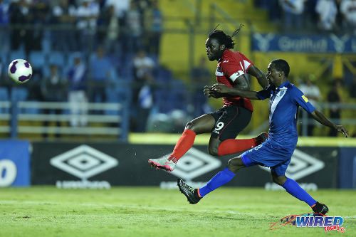 Photo: Trinidad and Tobago captain Kenwyne Jones (left) volleys home his country's second item despite the best efforts of Guatemala defender Dennis Lopez. The "Soca Warriors" won their opening 2018 World Cup qualifier 2-1 in Guatemala City on 13 November 2015. (Courtesy Allan V Crane/Wired868)